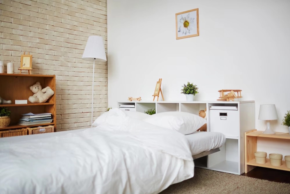 Freshly made bed with white linens in a bright bedroom